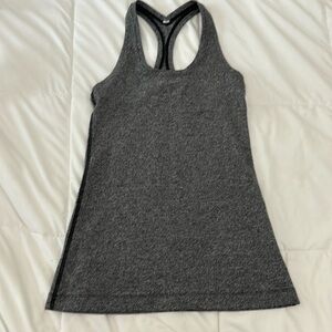 Like new! Lululemon x-small racer back yoga or exercise top. Body contouring.